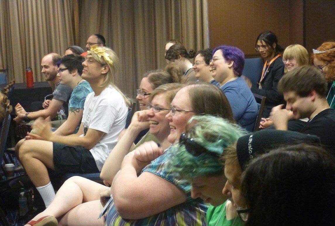 Attendees laughing during a panel