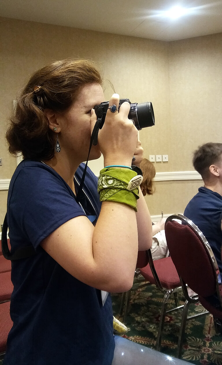 Sonia takes a picture with a camera